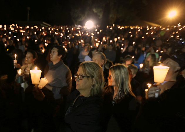 Community members gather for a candlelight vigil for those killed in a shooting at Umpqua Community College in Roseburg, Ore., Thursday, Oct. 1, 2015. (AP Photo/Rich Pedroncelli)