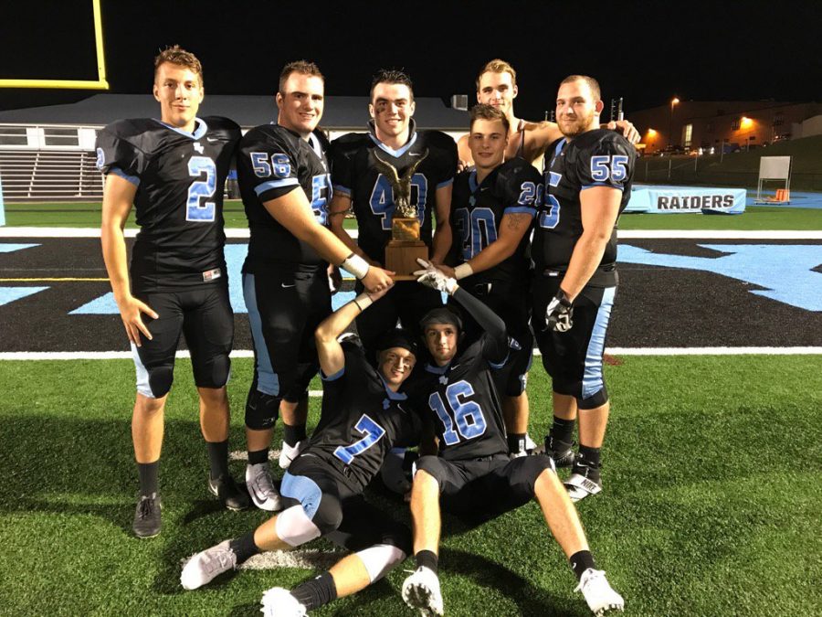 Members of the Raiders celebrate after claiming the Eagle Traveling Trophy